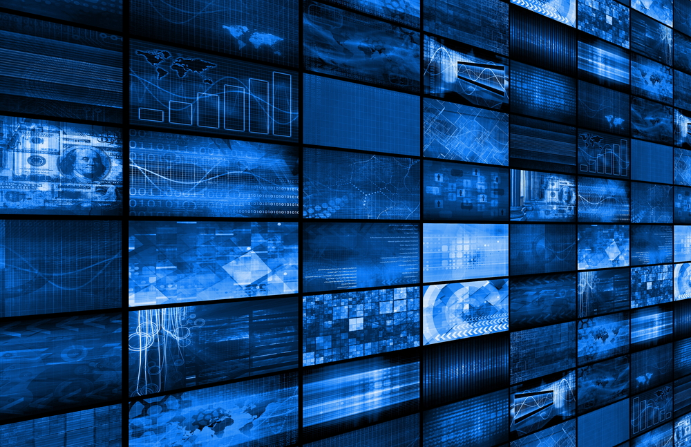 Wall of video surveillance monitors displaying multiple camera feeds